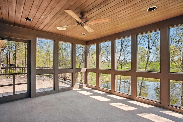 unfurnished sunroom with recessed lighting, carpet floors, wood ceiling, and ceiling fan