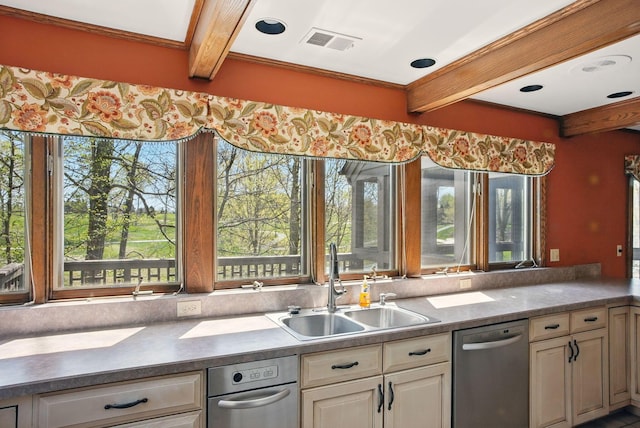 kitchen with dark countertops, a sink, dishwasher, beamed ceiling, and visible vents