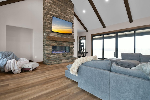 living area with a fireplace, recessed lighting, beamed ceiling, high vaulted ceiling, and wood finished floors