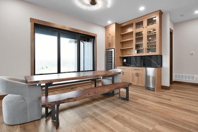 dining room with visible vents, baseboards, light wood-type flooring, wine cooler, and recessed lighting