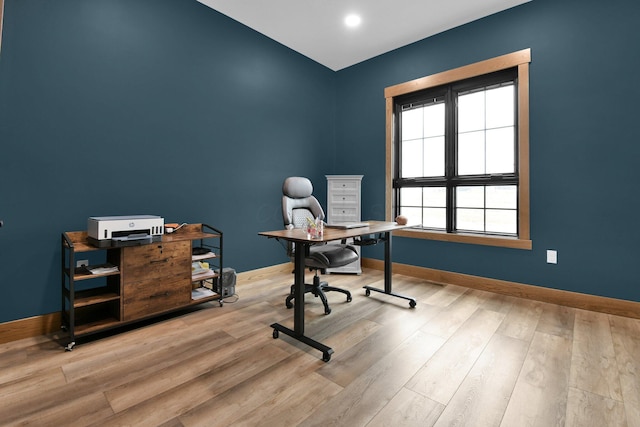 office space with baseboards and wood finished floors