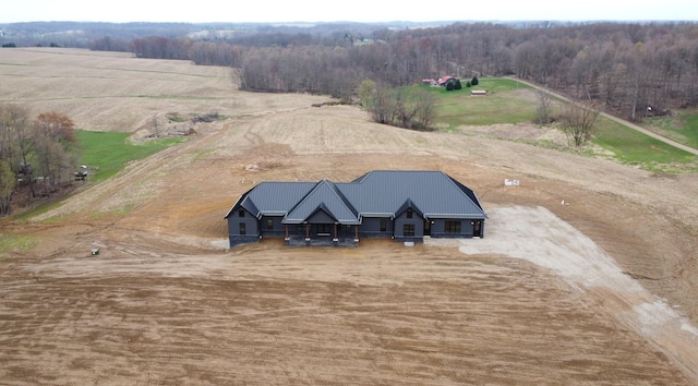 aerial view featuring a forest view and a rural view