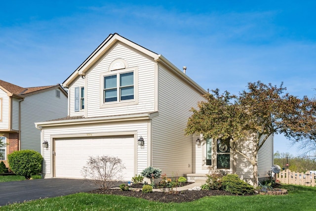 traditional-style home featuring a garage and aphalt driveway