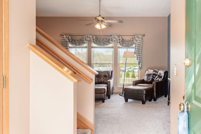sitting room featuring carpet floors and a ceiling fan