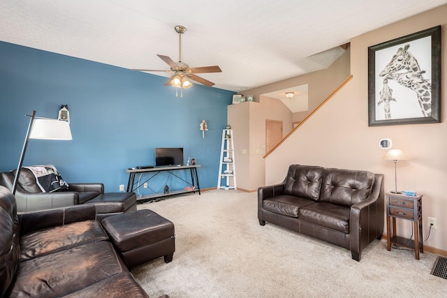 carpeted living room with stairway, baseboards, ceiling fan, and lofted ceiling