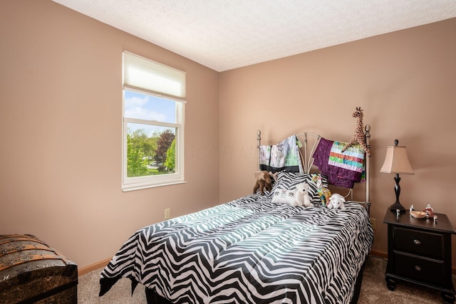 bedroom featuring baseboards and dark carpet