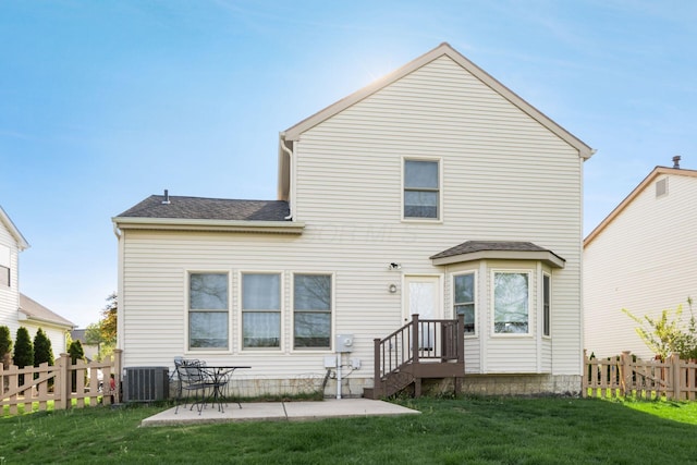 rear view of property with fence, a patio, a lawn, and central air condition unit