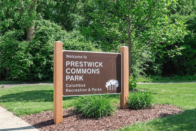 community / neighborhood sign with a lawn