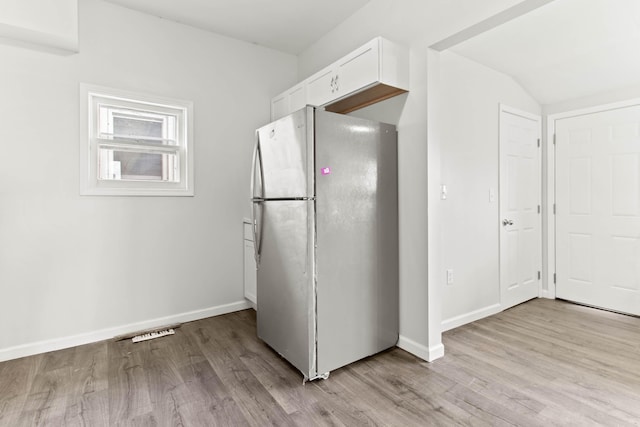 378 Maple Ave, Newark, OH 43055 - kitchen with light wood-style floors, baseboards, freestanding refrigerator, and white cabinetry