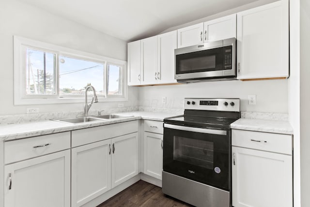 378 Maple Ave, Newark, OH 43055 - kitchen featuring dark wood-style flooring, lofted ceiling, white cabinets, a sink, and stainless steel appliances