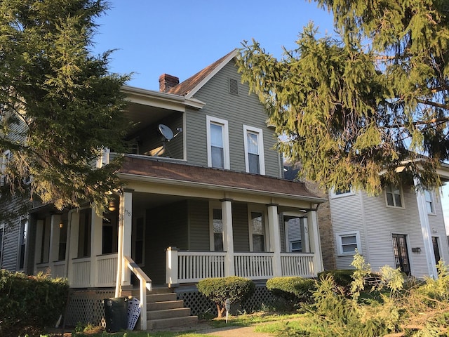 438 E 15th Ave, Columbus, OH 43201 - view of front of house featuring a porch and a chimney