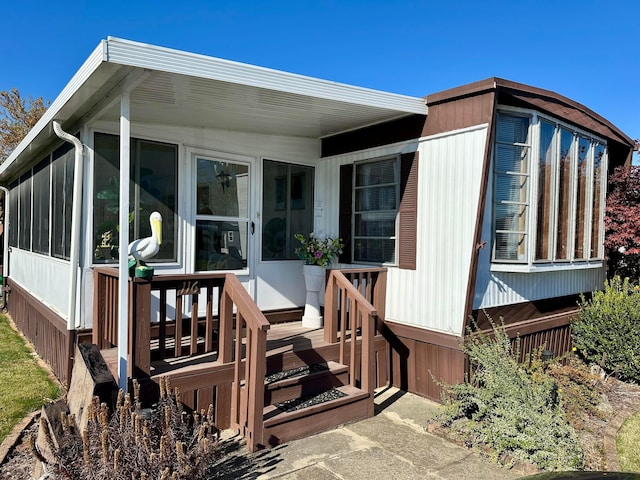 back of property with a sunroom