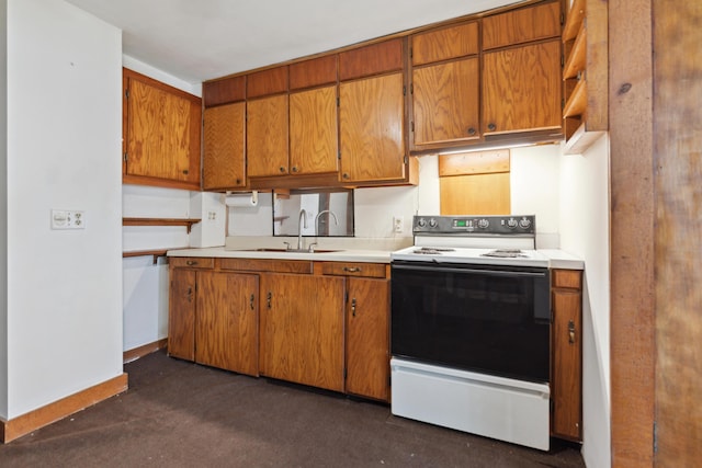 9 S 11th St, Newark, OH 43055 - kitchen with range with electric stovetop, a sink, brown cabinetry, and light countertops