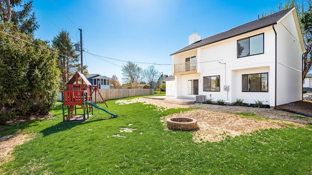 500 Hemlock Pl, Newark, OH 43055 - back of property featuring central AC, a playground, a lawn, a balcony, and an outdoor fire pit