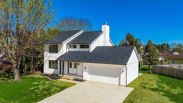 500 Hemlock Pl, Newark, OH 43055 - view of front of home with a chimney, driveway, an attached garage, fence, and a front yard