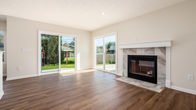 500 Hemlock Pl, Newark, OH 43055 - unfurnished living room with recessed lighting, wood finished floors, a tile fireplace, and baseboards