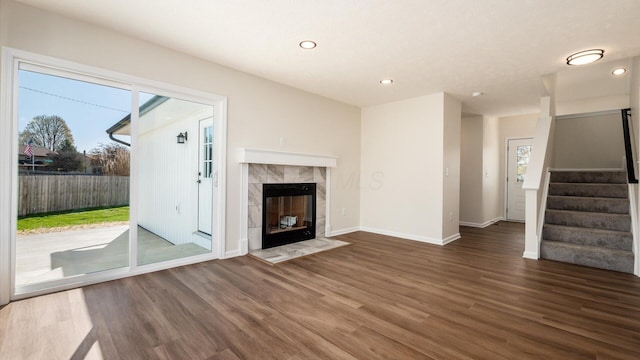 500 Hemlock Pl, Newark, OH 43055 - unfurnished living room featuring wood finished floors, a healthy amount of sunlight, baseboards, and stairway