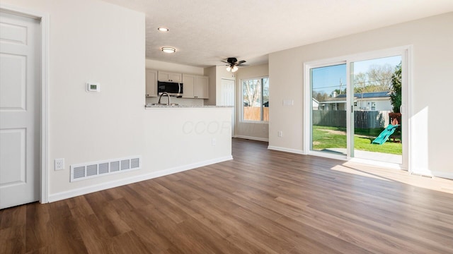 500 Hemlock Pl, Newark, OH 43055 - unfurnished living room with recessed lighting, wood finished floors, visible vents, baseboards, and ceiling fan