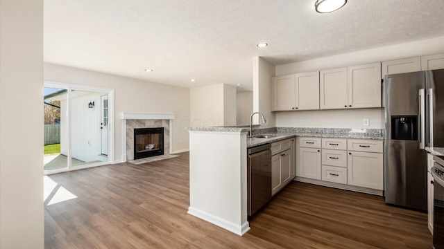 500 Hemlock Pl, Newark, OH 43055 - kitchen with stainless steel appliances, a sink, dark wood-type flooring, light stone countertops, and open floor plan