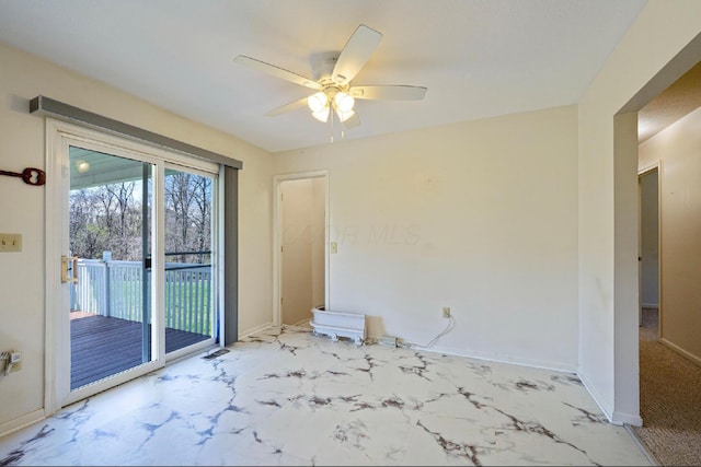 unfurnished room with marble finish floor, baseboards, and ceiling fan