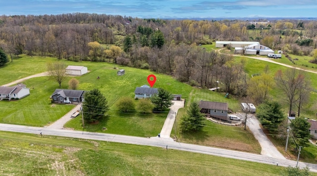 drone / aerial view featuring a wooded view