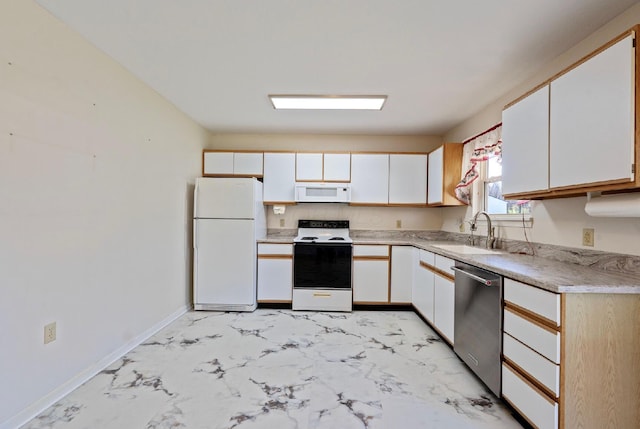 kitchen featuring white cabinetry, marble finish floor, a sink, and white appliances
