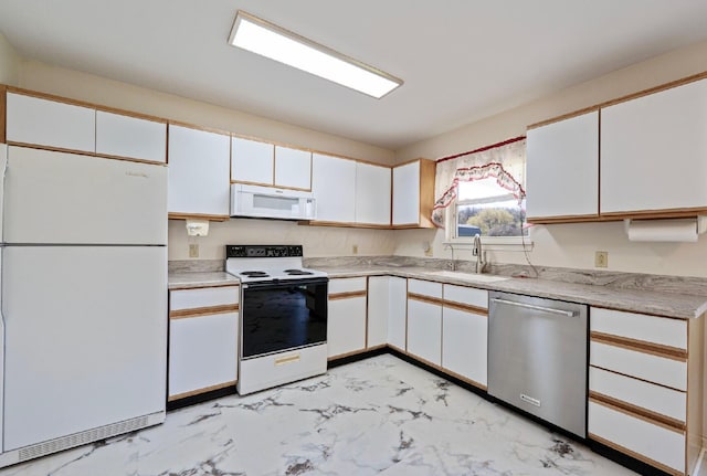 kitchen featuring a sink, white cabinetry, white appliances, and marble finish floor