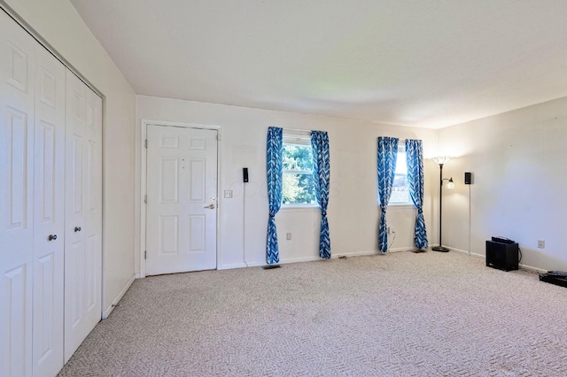unfurnished bedroom with a closet, carpet flooring, and baseboards