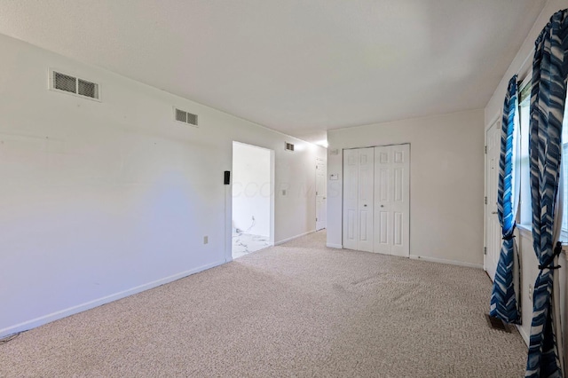 unfurnished bedroom with visible vents, baseboards, and carpet floors