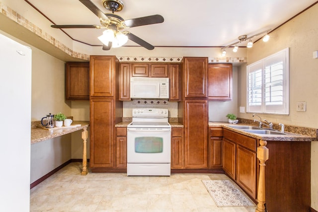 5072 Teddy Dr, Columbus, OH 43227 - kitchen featuring white appliances, brown cabinets, a sink, and ceiling fan