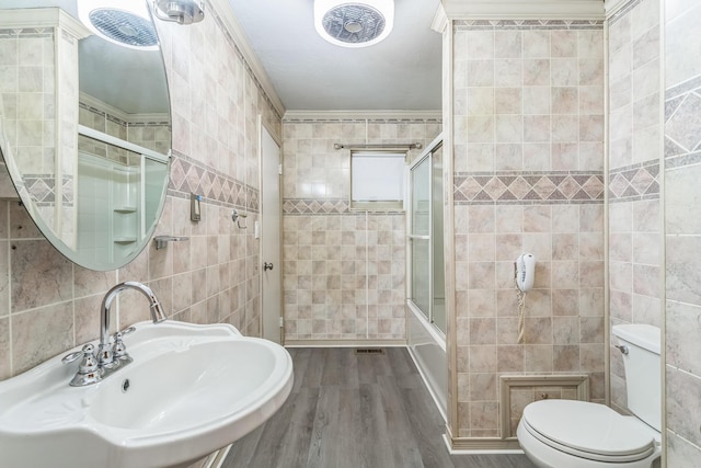 5072 Teddy Dr, Columbus, OH 43227 - full bath featuring toilet, tile walls, wood finished floors, and a sink