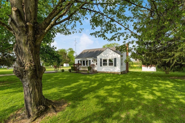 back of property featuring a yard and a chimney