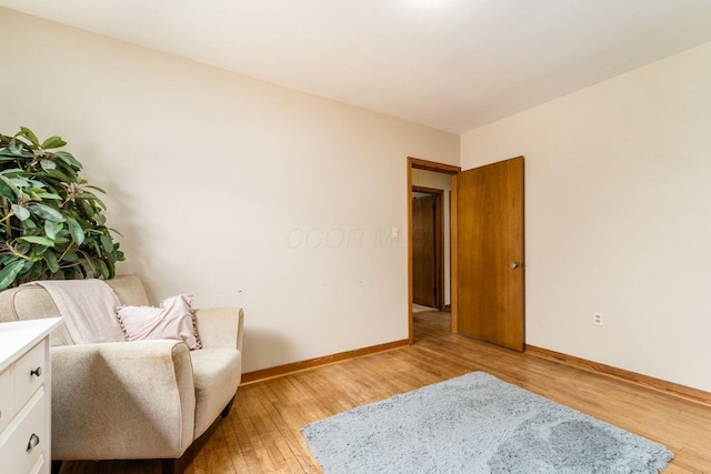 living area with light wood-style floors and baseboards