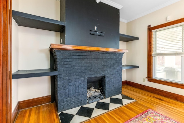 1297 S 4th St, Columbus, OH 43206 - details with baseboards, a brick fireplace, wood finished floors, and ornamental molding