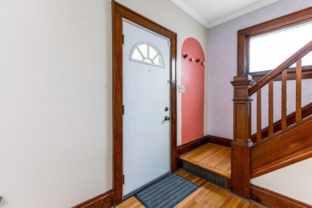 1297 S 4th St, Columbus, OH 43206 - foyer entrance featuring arched walkways, stairway, wood finished floors, and ornamental molding
