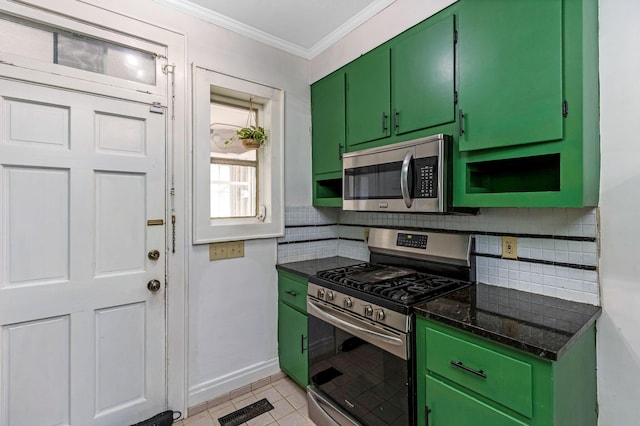 1297 S 4th St, Columbus, OH 43206 - kitchen with decorative backsplash, green cabinetry, stainless steel appliances, and visible vents