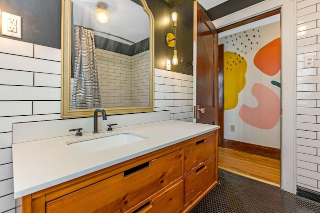1297 S 4th St, Columbus, OH 43206 - bathroom with tile walls, tile patterned floors, and vanity