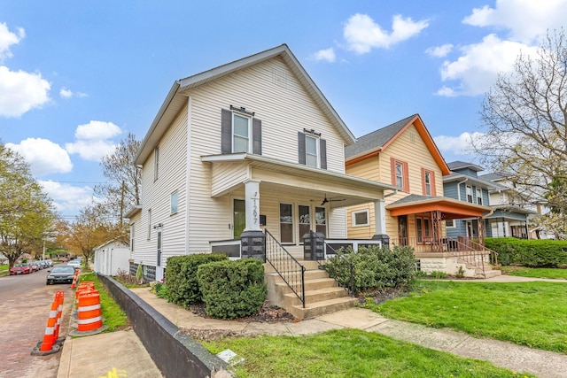 1297 S 4th St, Columbus, OH 43206 - american foursquare style home featuring a front yard and covered porch