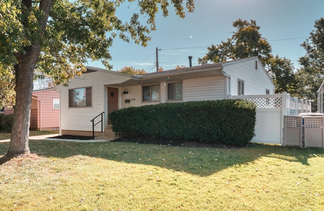 view of front of property with a front yard and fence