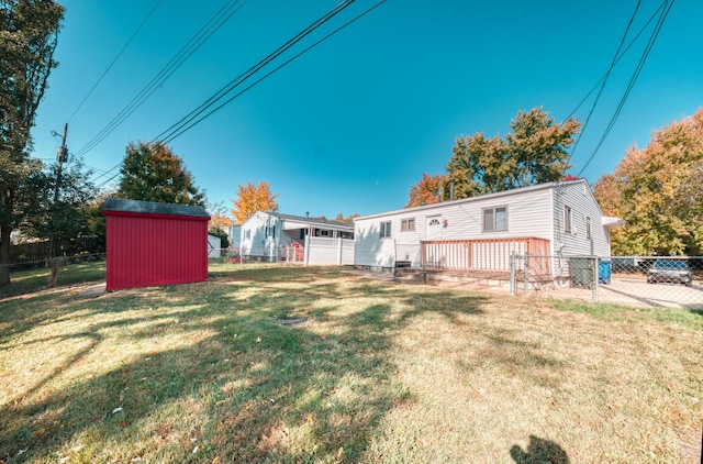 view of yard with a fenced backyard, an outdoor structure, and a shed