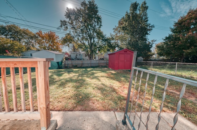 view of yard featuring a fenced backyard, an outdoor structure, and a shed