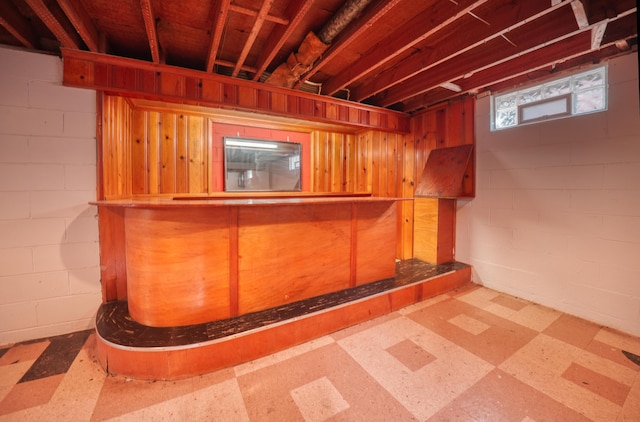 basement featuring tile patterned floors and concrete block wall