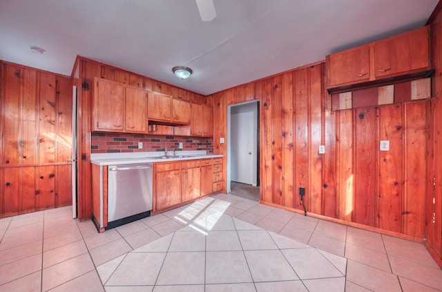 kitchen featuring brown cabinets, stainless steel dishwasher, and light countertops
