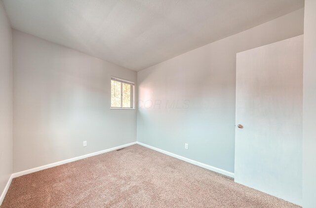 empty room with carpet floors and baseboards