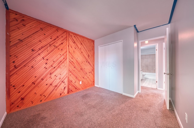 unfurnished bedroom with a closet and carpet flooring
