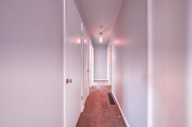 corridor featuring carpet flooring and visible vents