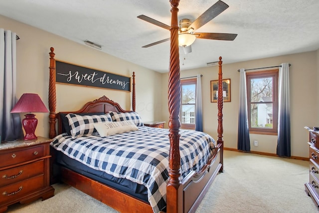 bedroom with visible vents, baseboards, ceiling fan, and light carpet