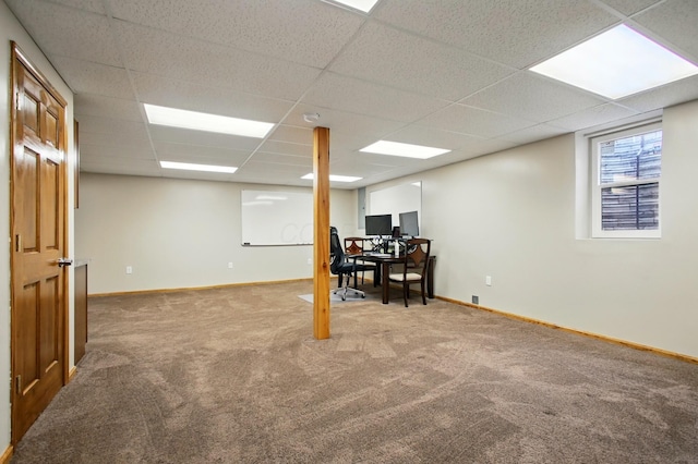 basement with baseboards, a drop ceiling, and carpet
