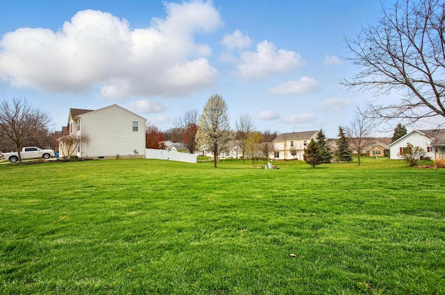 view of yard with a residential view and fence