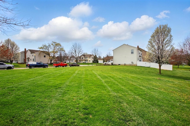view of yard with a residential view and fence